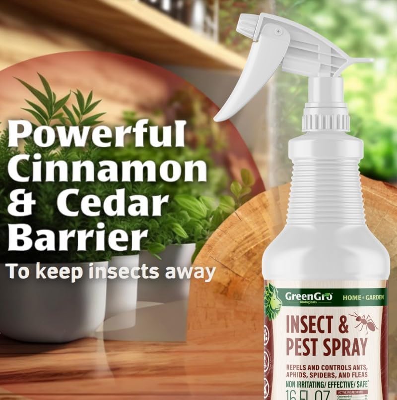 A 16 fl oz trigger spray bottle of GreenGro Insect & Pest Spray, featuring a white bottle and spray head with a green and brown label. The background is a warm, blurred kitchen or garden setting with wooden shelves and potted plants, accompanied by promotional text reading 'Powerful Cinnamon & Cedar Barrier'.
