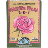 A box of Down to Earth Alfalfa Meal 2-0-1 all natural fertilizer, featuring a tan background with a large pink rose illustration and green side panels.
