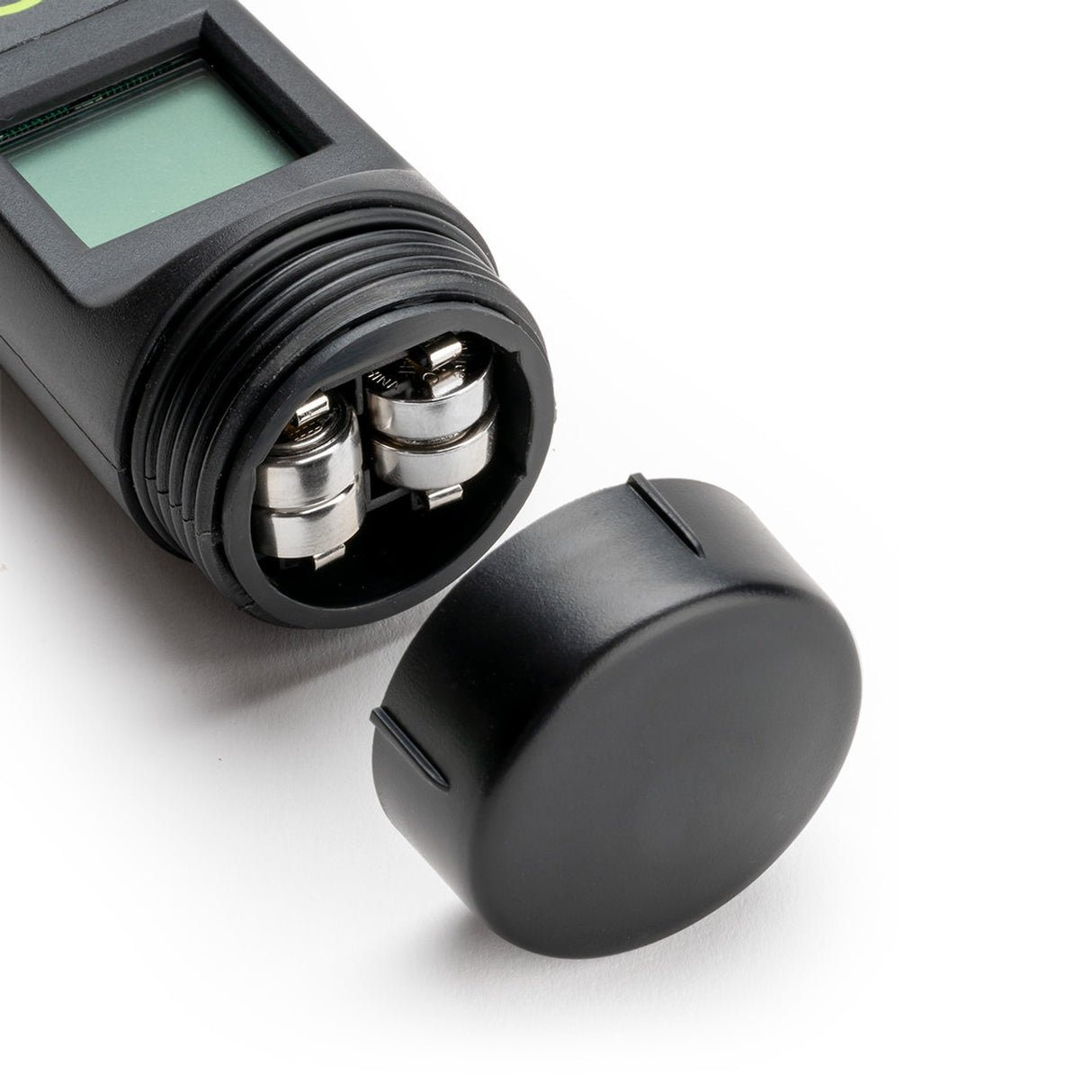Black electronic device with a digital display and cylindrical components on a white background