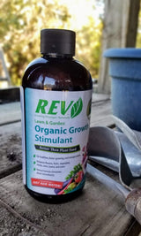 Bottle of Rev Organic Growth Stimulant on a wooden surface with a blurred background
