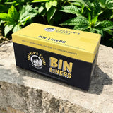 Box of Trapper's Choice Bin Liners on a stone surface with green plants in the background
