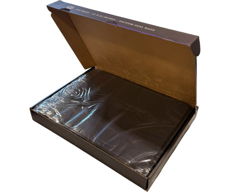 Open box containing vacuum seal bags with a clear plastic bag inside.